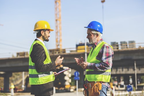 Prepare to make changes to your product or approach to meet new requirements Two construction workers discussing