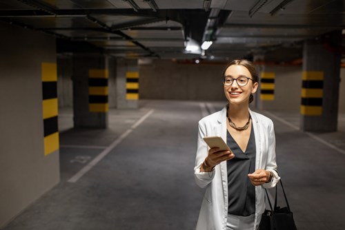 Meet your clients needs but don't forget about the end-user Woman in the underground parking looking at phone