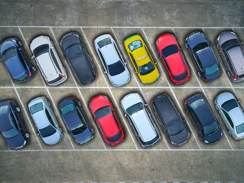Aerial view of cars parked in bays in a lot