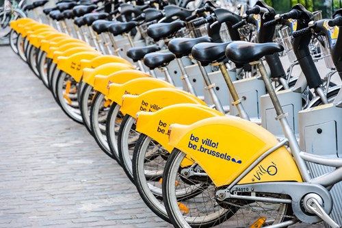 Row of shared bicycles parked at the "Mort Subite" Villo! station in the historic center of Brussels, Belgium