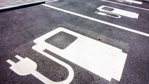 Parking spaces painted with EV charging station icons