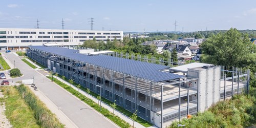 Multistory steel car park with solar panel roof top.