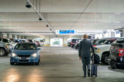 man walking in a parking garage