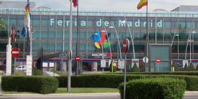 Exterior of the IFEMA Convention Center with glass front and flagposts