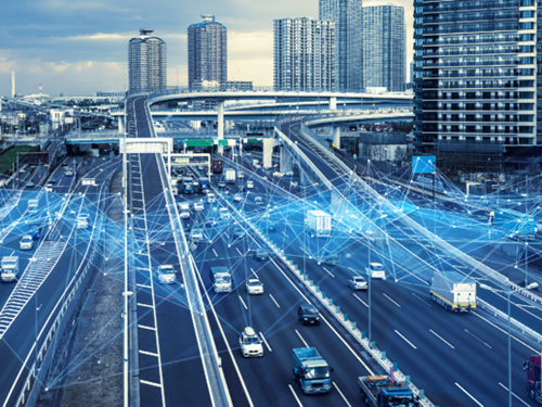 Busy road in the modern city with skyscrappers in the background