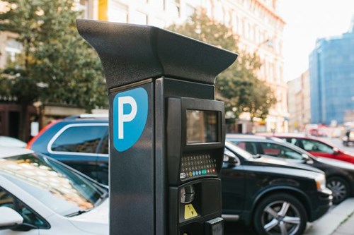 Parking machine with on-street parking in background