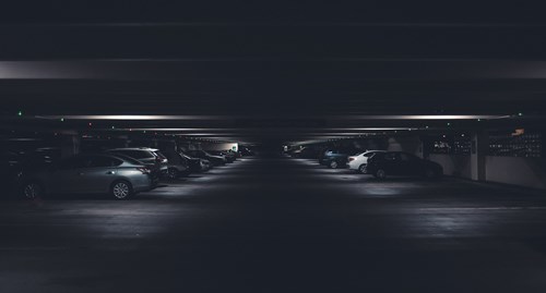 Dark Indoor Parking Lot With Two Rows of Cars