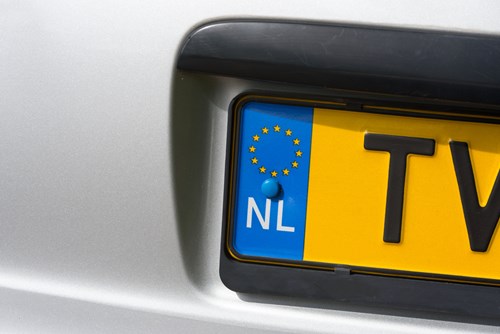 Zoomed in yellow license plate, display NL country code