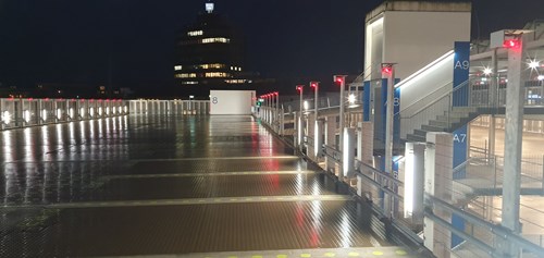 Rooftop of a parking garage with bays and staircases