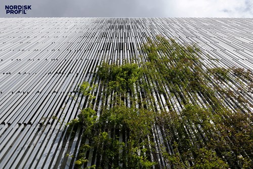 Nordisk Profil facade with greenery growing on it.