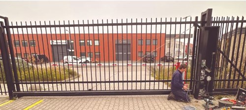 Barrier and sliding gate