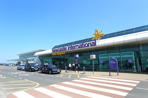 Exterior of Newcastle International Airport, cars parked outside entrance