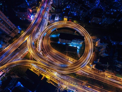 Aerial view of a highway flyover, illuminated at night