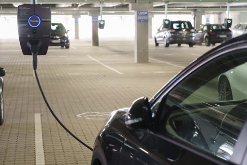 image of a car being charged in a parking lot