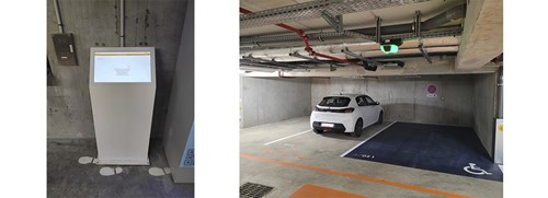 Find Your Car kiosk and vacant disabled parking bay in a parking garage with a white car in the next bay