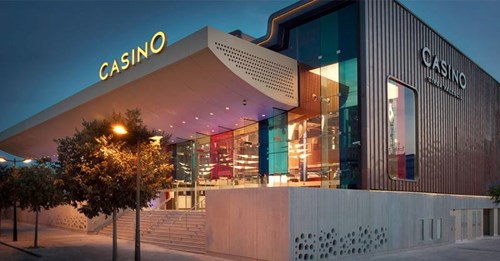 Casino building with wooden cladding and Casino light on roof, trees in front of the building