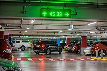 Green parking guidance sign shows 45 spaces are available ahead and 39 are available to the right.
