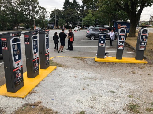 Five Pay Stations arranged in a square with a parking lot surrounded by trees
