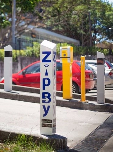 A ZipBy post by the access and exit of an outdoor car park