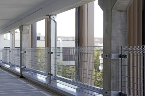 Parking spaces in parking lot with fall protection barriers by windows