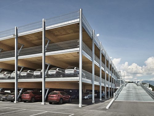 Wooden multi-storey car park with metal safety barriers